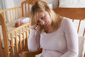 Mother In Nursery Suffering From Post Natal Depression